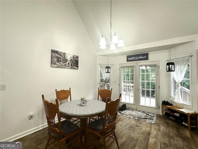 dining room with french doors, high vaulted ceiling, dark hardwood / wood-style flooring, and an inviting chandelier