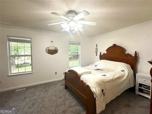 carpeted bedroom featuring ceiling fan, ornamental molding, and a textured ceiling