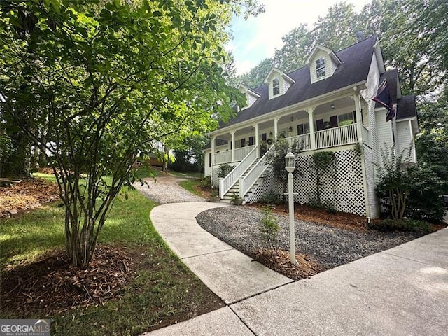 new england style home featuring covered porch