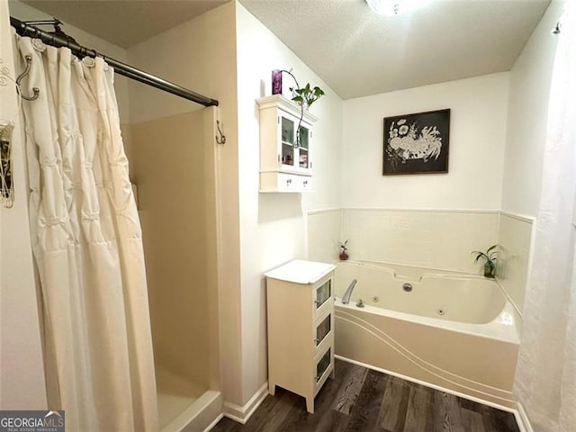 bathroom with hardwood / wood-style flooring and independent shower and bath