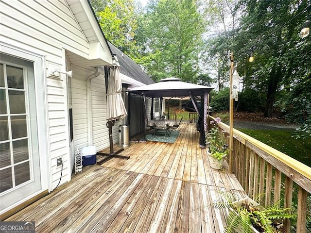 wooden terrace featuring a gazebo