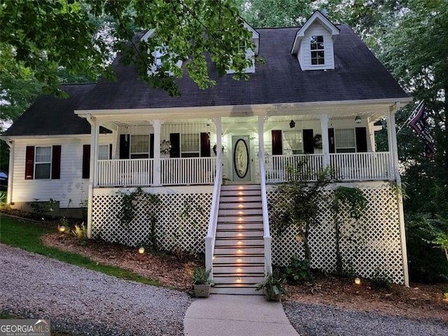 cape cod-style house featuring a porch