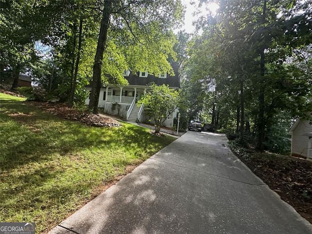 view of front of home with a front yard and a porch