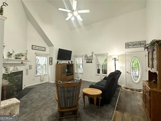 living room with ceiling fan and high vaulted ceiling