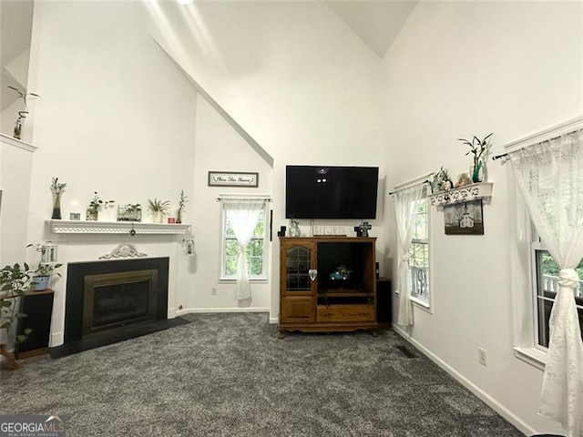 living room featuring dark carpet and high vaulted ceiling