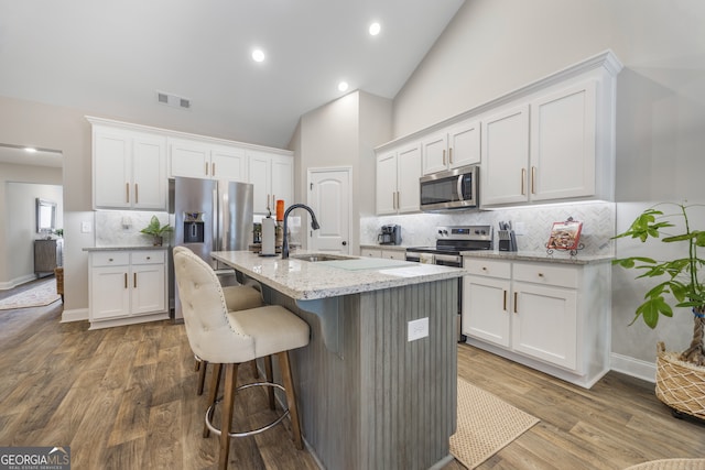 kitchen featuring white cabinetry, appliances with stainless steel finishes, and a sink