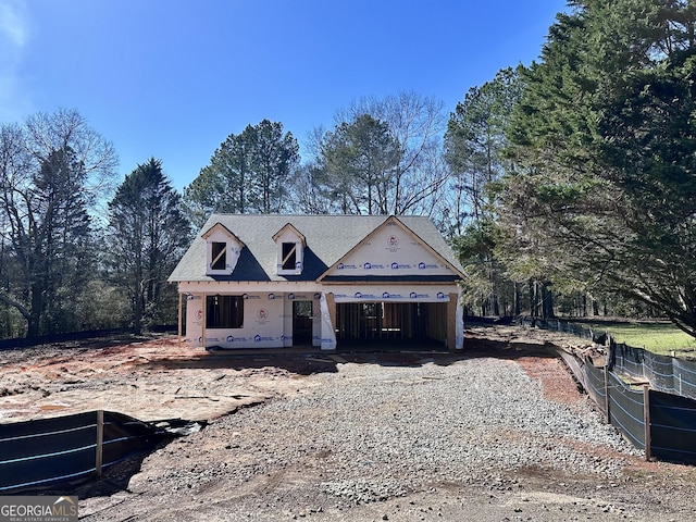 property in mid-construction featuring gravel driveway and covered porch