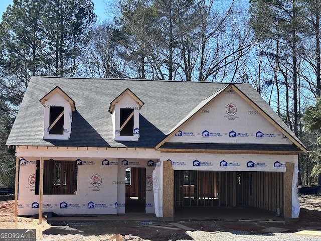 property under construction featuring roof with shingles and an attached garage