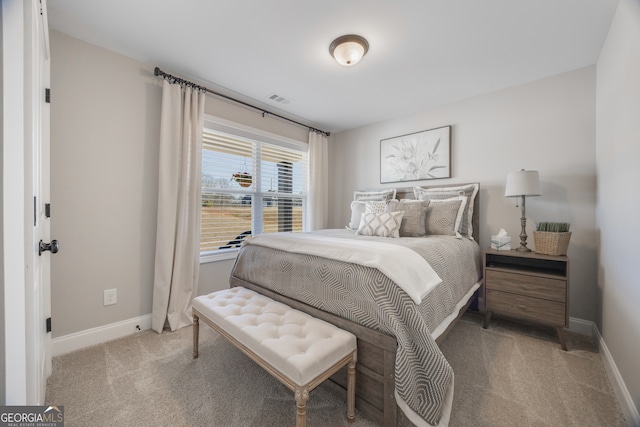 bedroom with carpet floors, visible vents, and baseboards