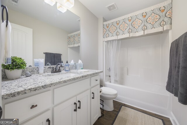 laundry area featuring washing machine and dryer, laundry area, baseboards, and wood finished floors