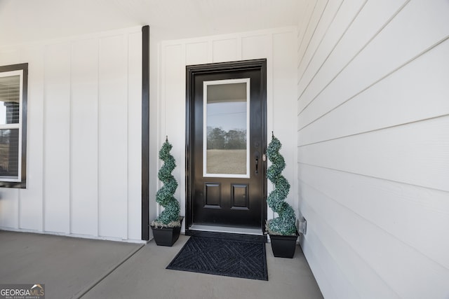 property entrance featuring board and batten siding