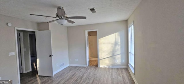 interior space with ceiling fan, hardwood / wood-style floors, and a textured ceiling