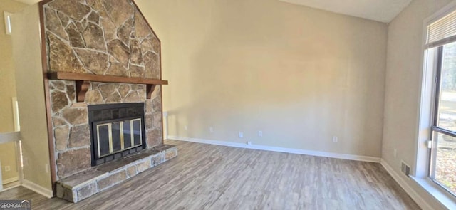 unfurnished living room with hardwood / wood-style floors and a fireplace