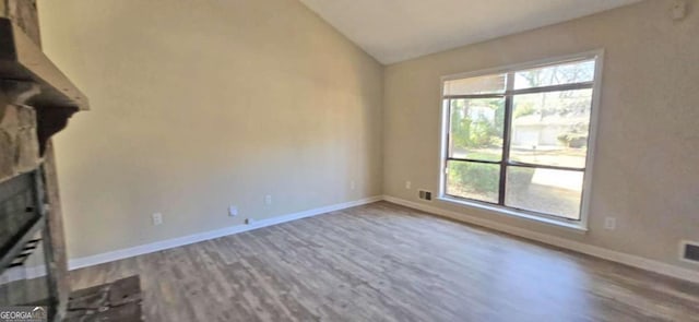 unfurnished living room with lofted ceiling and hardwood / wood-style flooring