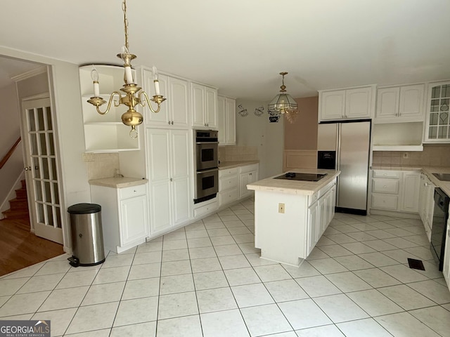 kitchen featuring pendant lighting, white cabinets, a center island, light tile patterned floors, and stainless steel appliances