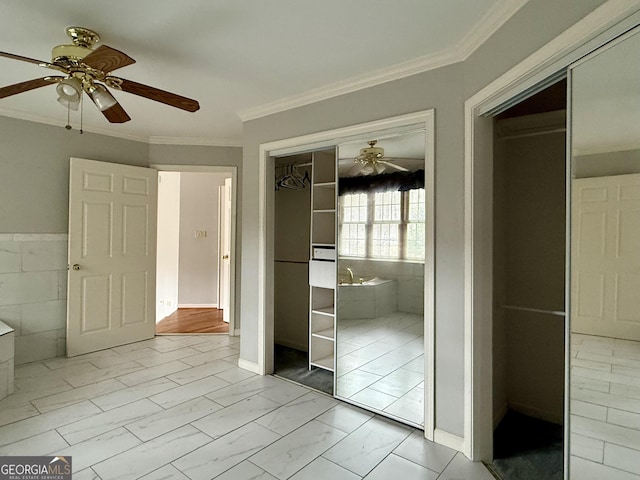 unfurnished bedroom featuring crown molding and ceiling fan