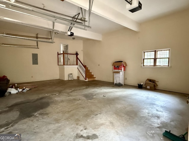 garage featuring a garage door opener and electric panel