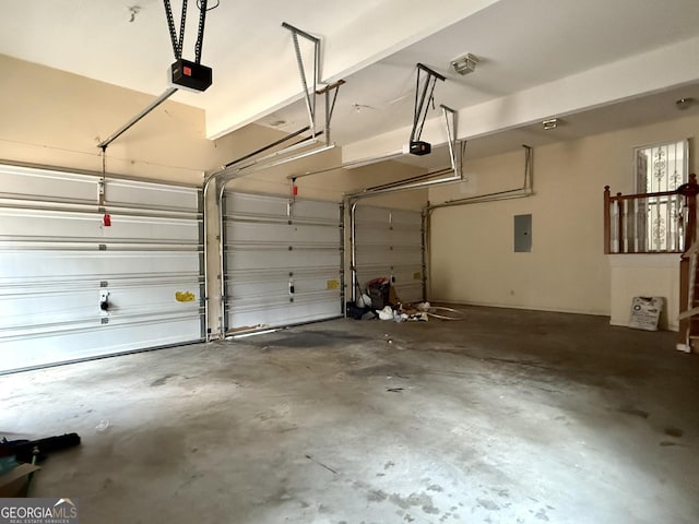 garage with a garage door opener and electric panel