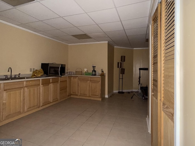 kitchen with crown molding, sink, a paneled ceiling, and light brown cabinets