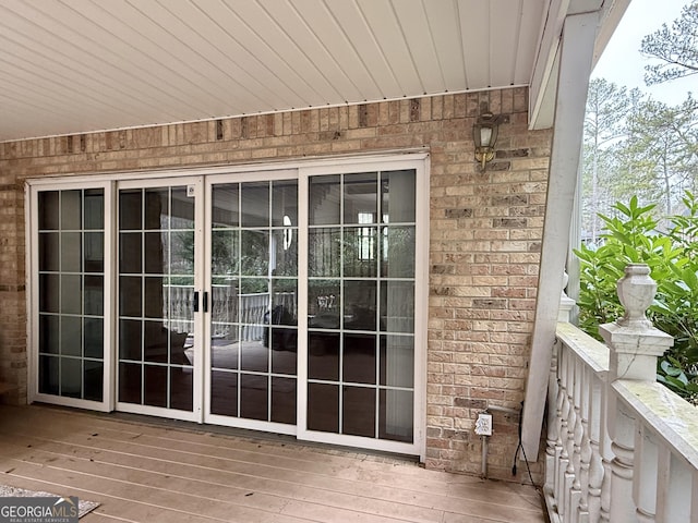 doorway to property featuring a wooden deck and french doors