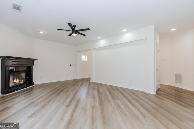 unfurnished living room featuring light hardwood / wood-style floors and ceiling fan