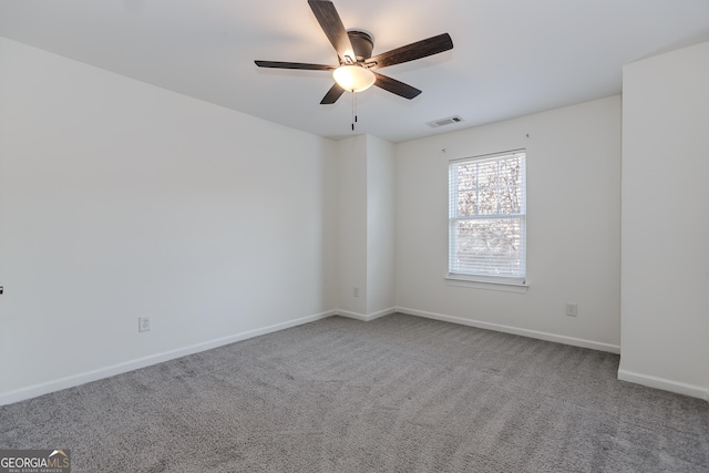 empty room with ceiling fan and carpet flooring