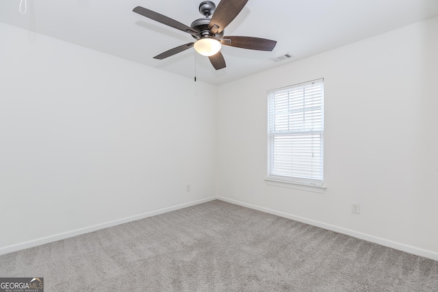 unfurnished room with ceiling fan and carpet flooring