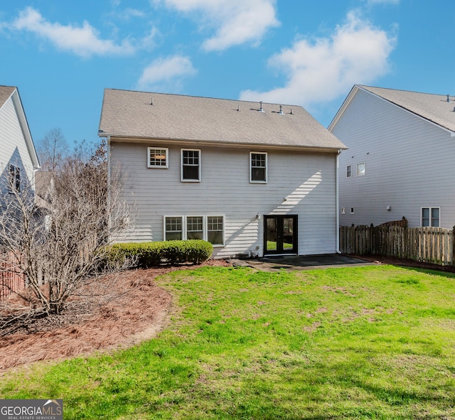 rear view of property featuring a yard and french doors