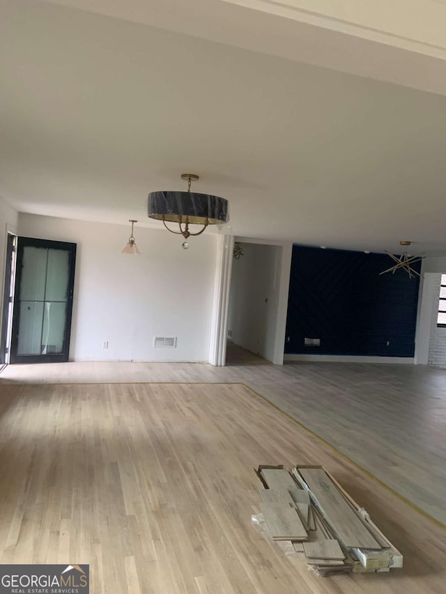 unfurnished living room with hardwood / wood-style floors