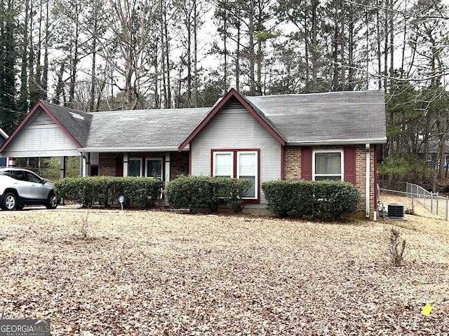 ranch-style home with cooling unit and a carport