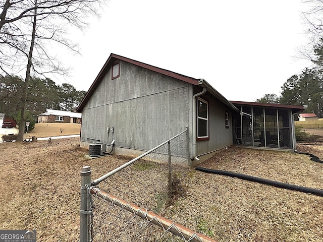 view of side of home featuring a sunroom and central air condition unit