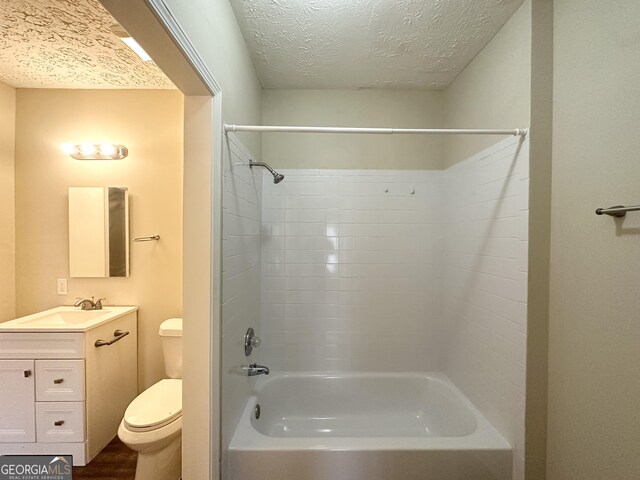 full bathroom featuring toilet, a textured ceiling, shower / tub combination, vanity, and hardwood / wood-style flooring