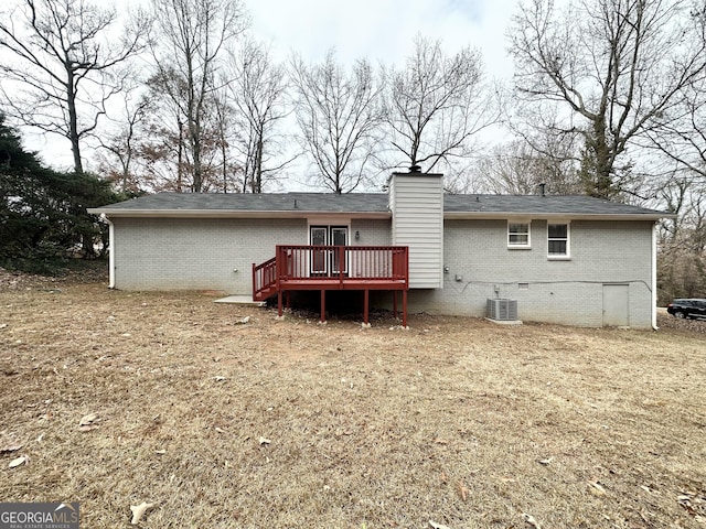 back of house with a lawn and a deck
