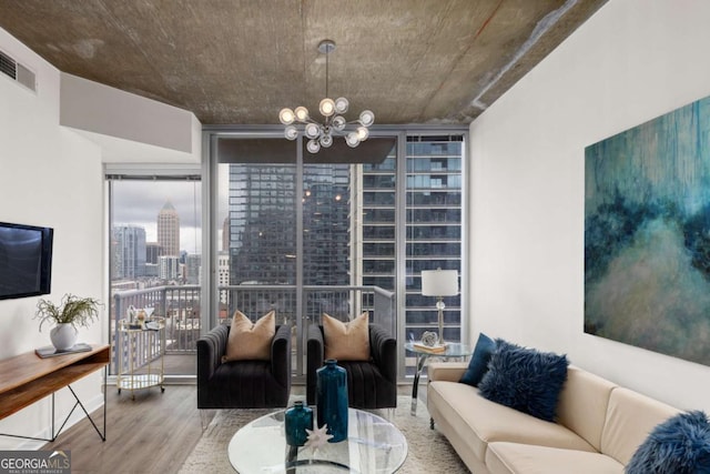 living room with floor to ceiling windows, wood-type flooring, and a notable chandelier