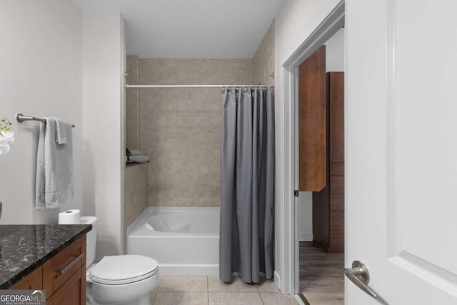 full bathroom with tile patterned flooring, shower / bath combo, vanity, and toilet