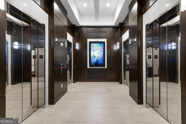 hall featuring elevator and wood walls