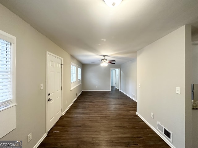 interior space featuring dark wood-type flooring and ceiling fan