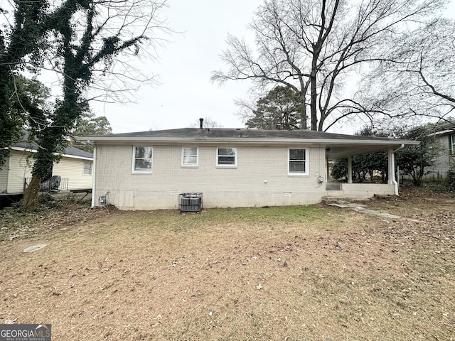 back of property featuring cooling unit and a lawn