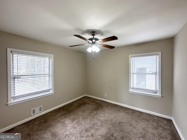 carpeted spare room featuring ceiling fan