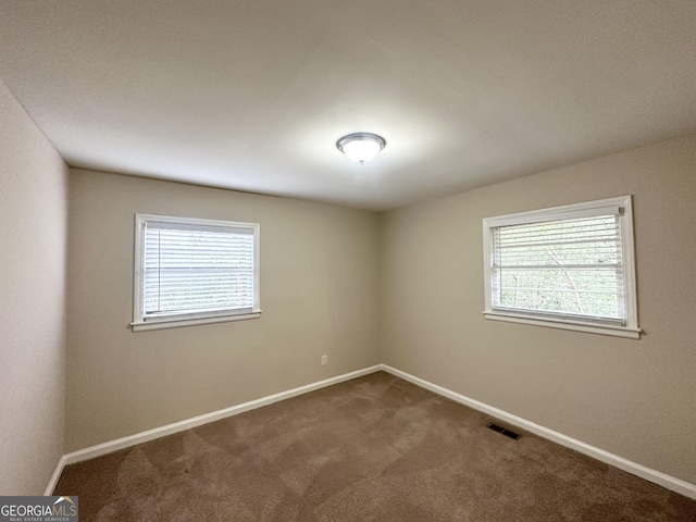 unfurnished room with carpet flooring