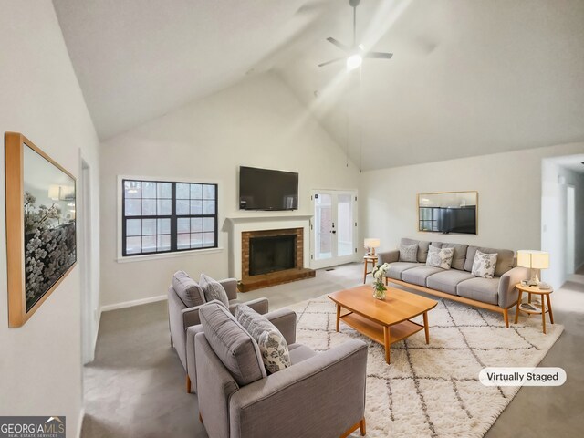 living room with light carpet, a fireplace, high vaulted ceiling, and ceiling fan