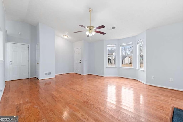 unfurnished room featuring vaulted ceiling, ceiling fan, and light hardwood / wood-style flooring