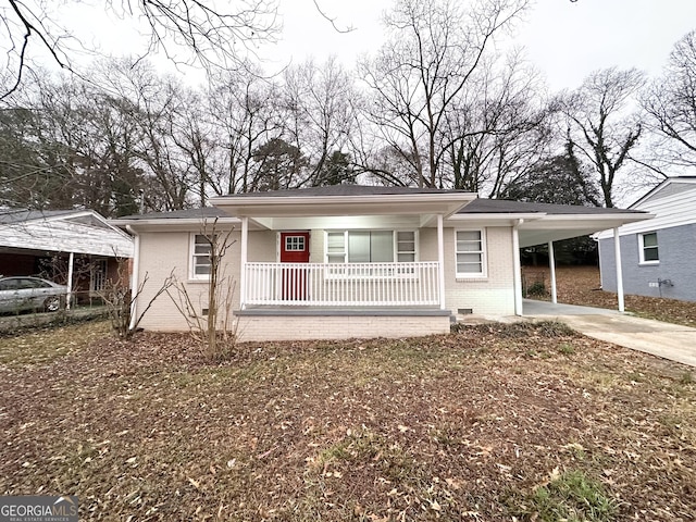 view of front of home with a carport and covered porch