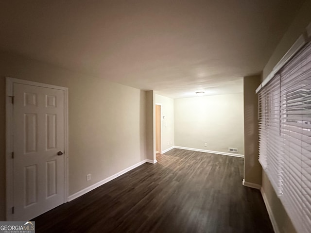 empty room with dark hardwood / wood-style floors