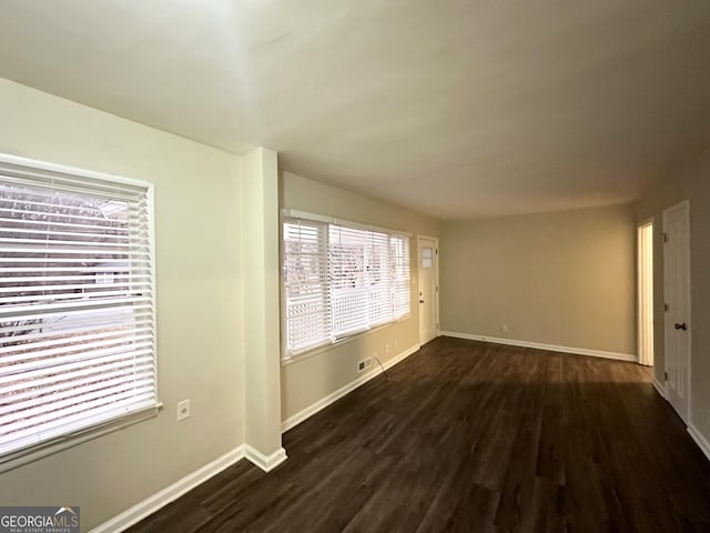 unfurnished room featuring dark hardwood / wood-style flooring