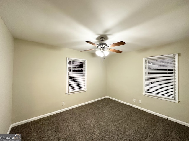 carpeted spare room featuring ceiling fan