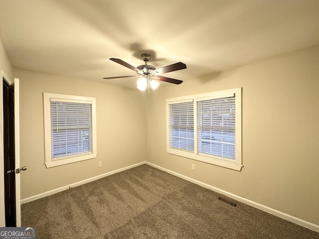 carpeted spare room with ceiling fan