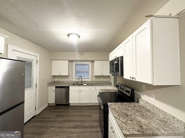 kitchen featuring dark hardwood / wood-style floors, sink, white cabinets, stainless steel appliances, and light stone countertops