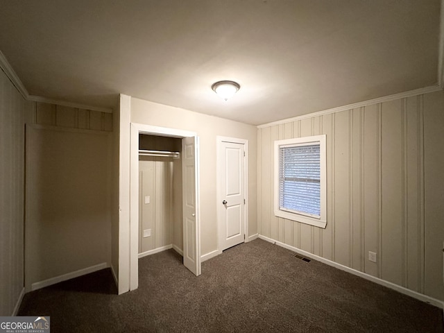 unfurnished bedroom with dark colored carpet