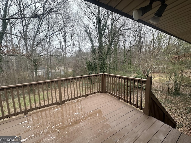 wooden deck featuring ceiling fan